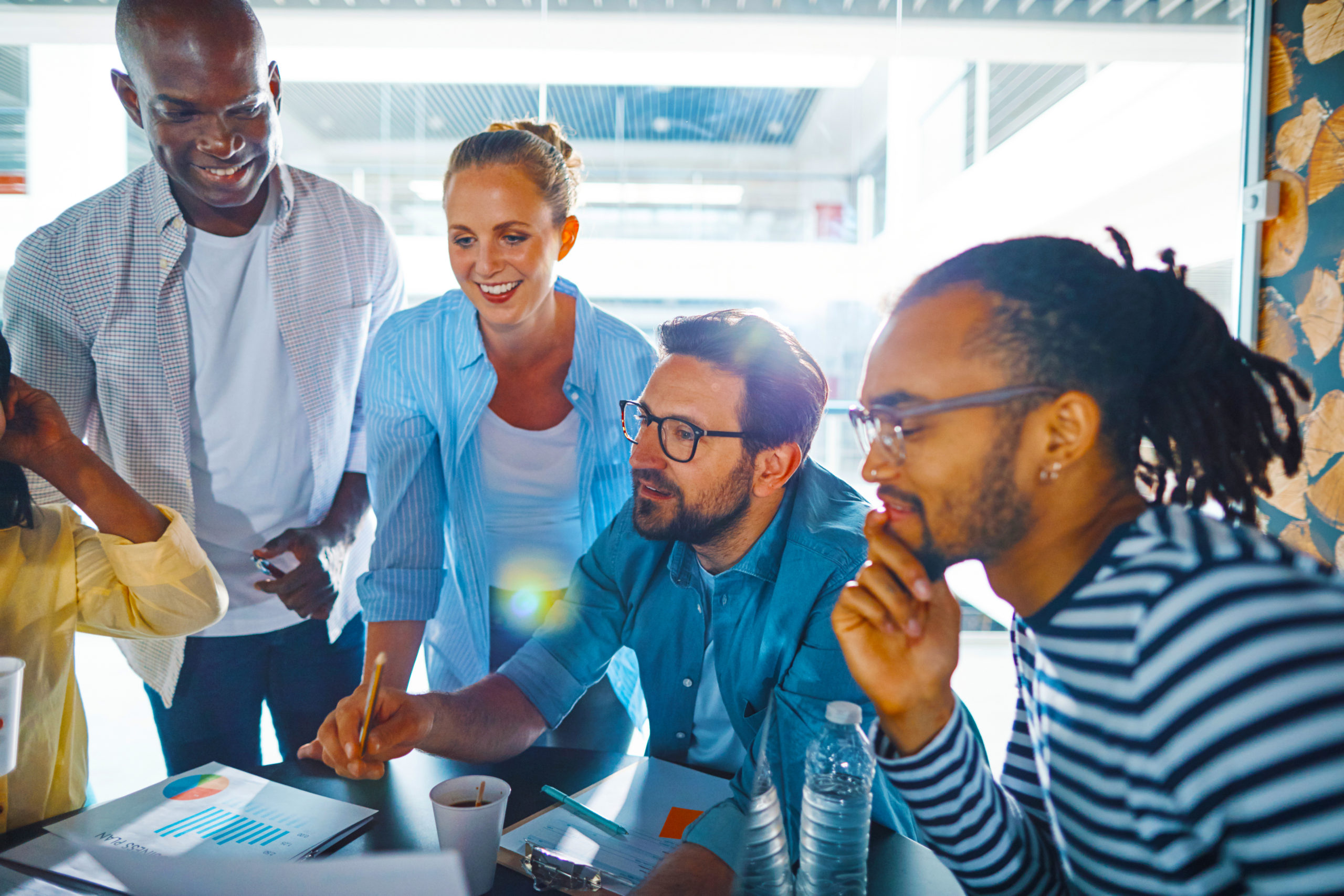 Laughing-group-of-diverse-businesspeople-meeting-in-an-office-scaled